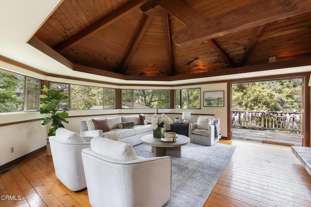 living room with wood ceiling, light wood-style floors, healthy amount of natural light, and baseboards