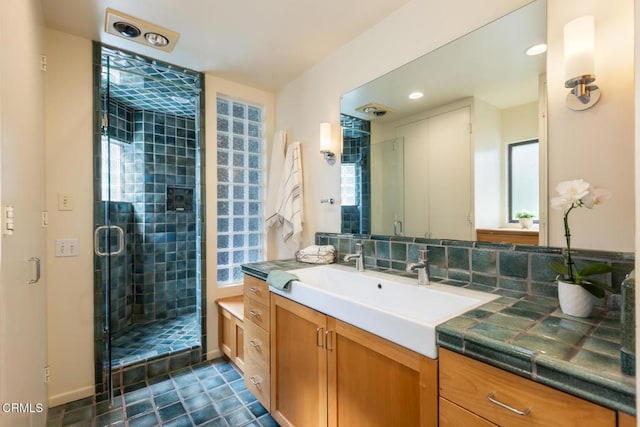 full bath with a shower stall, vanity, and recessed lighting