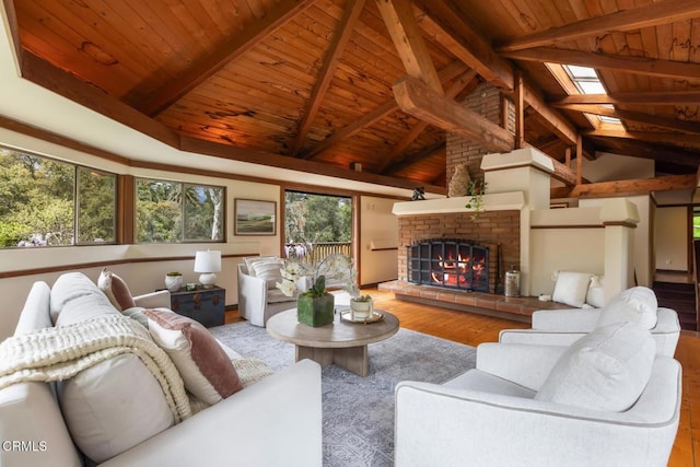 living room featuring wood ceiling, wood finished floors, a skylight, and a fireplace