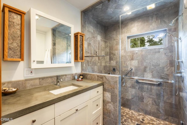 bathroom featuring a stall shower and vanity