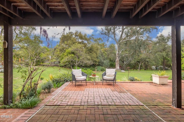 view of patio / terrace featuring view of wooded area