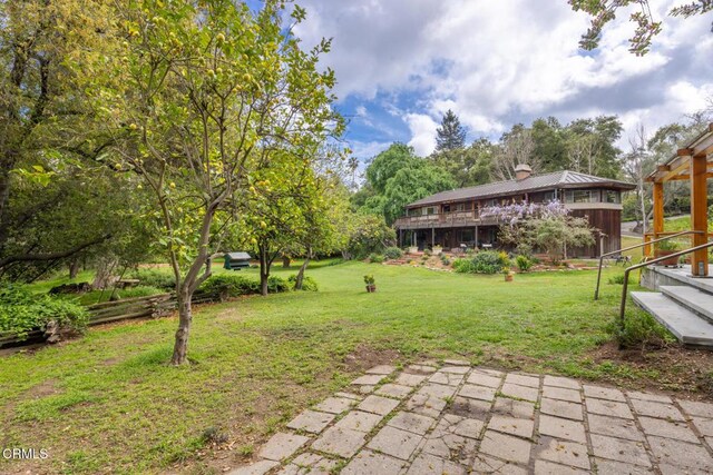 view of grassy yard featuring a deck