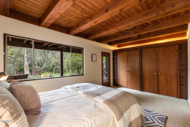 carpeted bedroom featuring wooden ceiling, beamed ceiling, and a closet