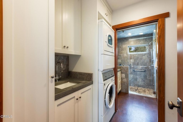 laundry area featuring estacked washer and dryer and cabinet space