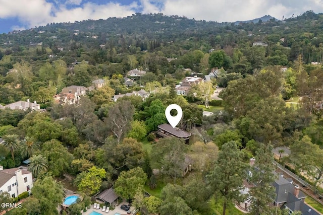 drone / aerial view of a forest and a pool