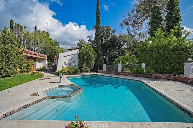 view of pool with a pool with connected hot tub and a patio