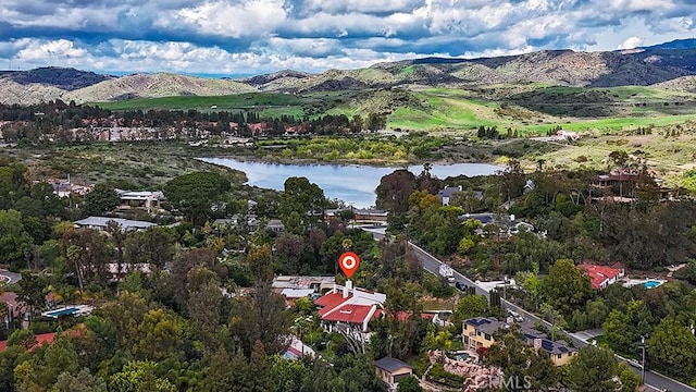 aerial view of property's location with a water and mountain view