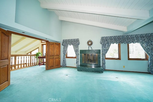 unfurnished living room featuring light carpet, beamed ceiling, wood ceiling, plenty of natural light, and a premium fireplace