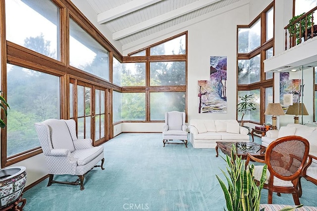living room with high vaulted ceiling, carpet, beamed ceiling, and baseboards