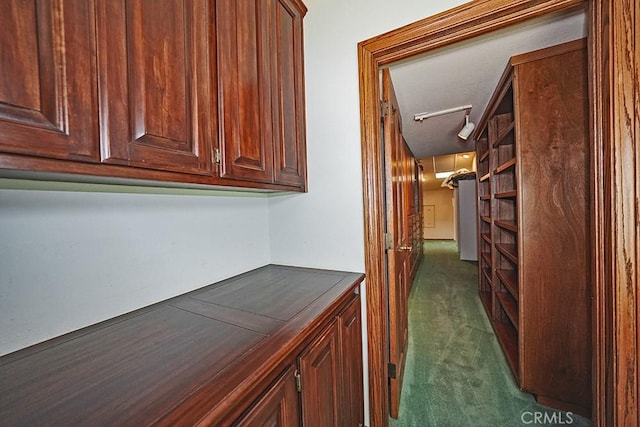 corridor with dark colored carpet