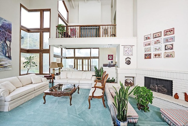 living area featuring a towering ceiling and a fireplace