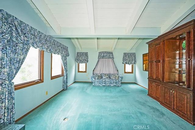 unfurnished living room with healthy amount of natural light, light carpet, and baseboards
