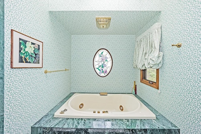 bathroom with a tub with jets