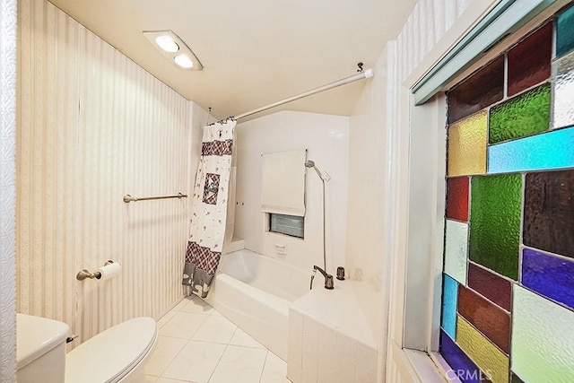 bathroom with toilet, tile patterned floors, and shower / tub combo with curtain