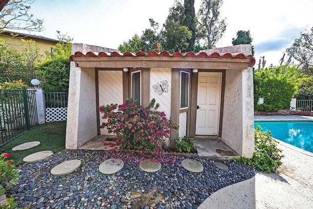 view of outbuilding with fence
