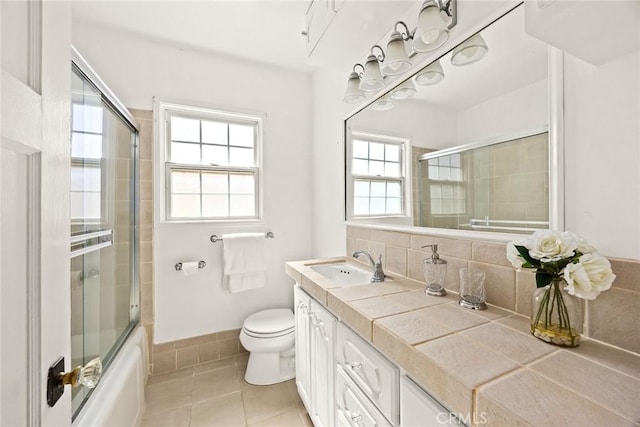 333 W Andrix St, Monterey Park, CA 91754 - full bath with tile patterned flooring, toilet, vanity, tasteful backsplash, and combined bath / shower with glass door