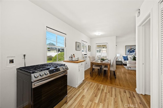 333 W Andrix St, Monterey Park, CA 91754 - kitchen featuring stainless steel gas range oven, light wood-style flooring, white cabinets, and butcher block counters