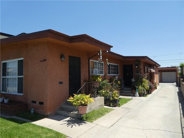 view of front of home featuring stucco siding, driveway, and a garage