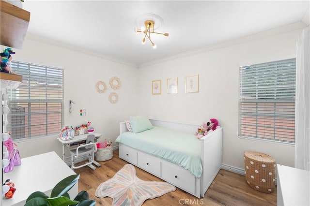 5927 Mckinley Ave, South Gate, CA 90280 - bedroom featuring light wood-style floors and ornamental molding