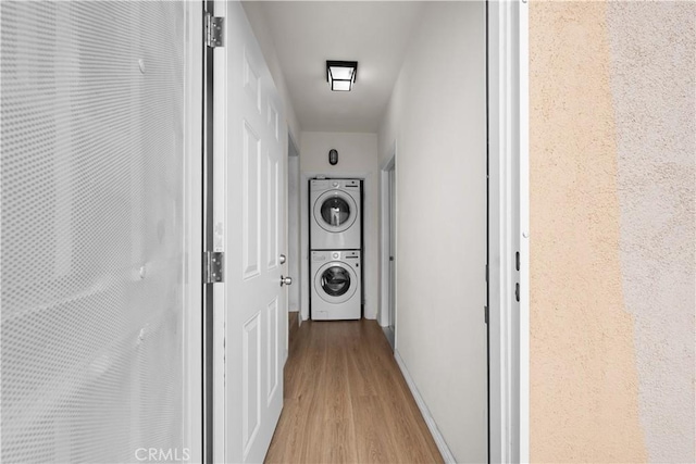 5927 Mckinley Ave, South Gate, CA 90280 - hall featuring stacked washer / dryer, light wood-style floors, and baseboards