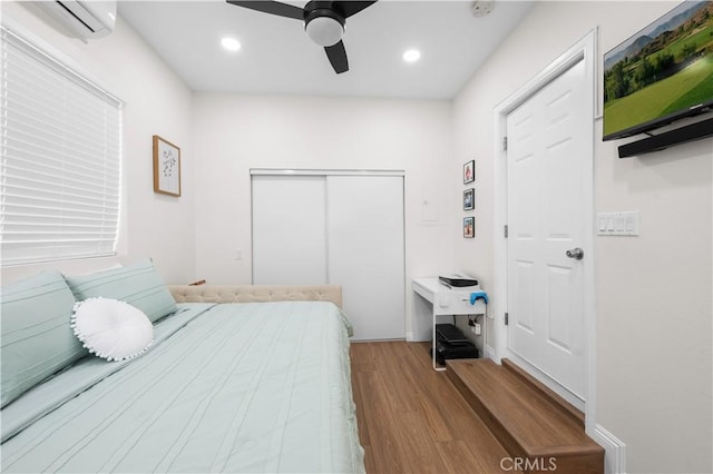 5927 Mckinley Ave, South Gate, CA 90280 - bedroom featuring wood finished floors, a wall mounted AC, a closet, recessed lighting, and ceiling fan