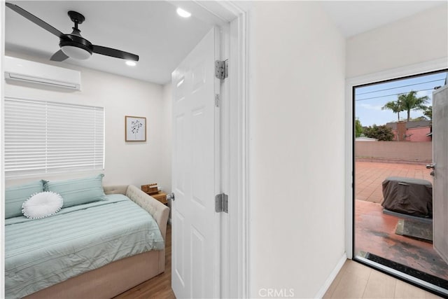 5927 Mckinley Ave, South Gate, CA 90280 - bedroom featuring a wall mounted AC, access to exterior, and baseboards