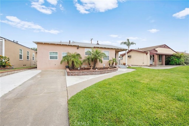 5927 Mckinley Ave, South Gate, CA 90280 - view of front facade featuring stucco siding, a front lawn, and driveway