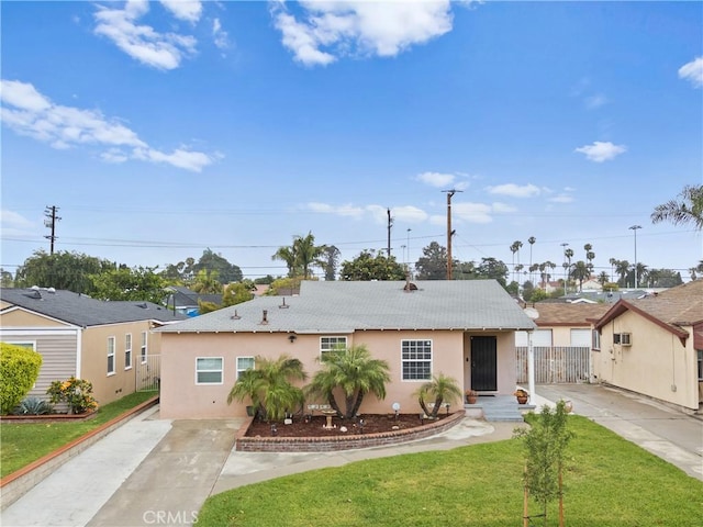 5927 Mckinley Ave, South Gate, CA 90280 - view of front facade featuring stucco siding, concrete driveway, and roof with shingles