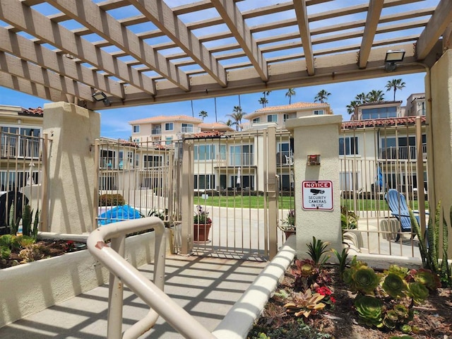 600 N The Strand Unit 12, Oceanside, CA 92054 - view of patio featuring fence, a gate, and a pergola