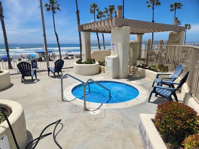 600 N The Strand Unit 12, Oceanside, CA 92054 - view of pool featuring a water view, fence, a patio area, and a community hot tub