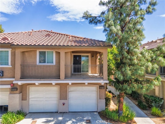 25892 Iris Ave Unit A, Moreno Valley, CA 92551 - view of front of property with concrete driveway, stucco siding, a garage, and a tiled roof