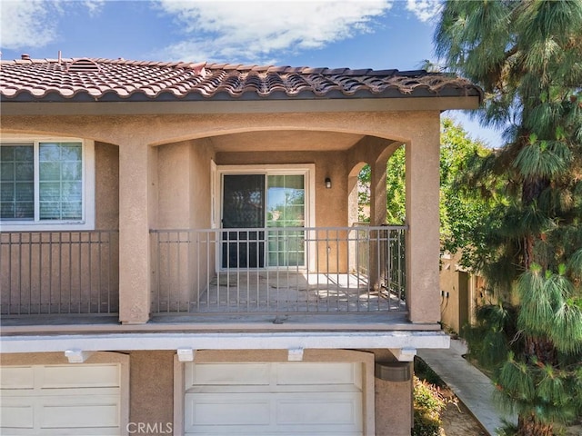 25892 Iris Ave Unit A, Moreno Valley, CA 92551 - view of exterior entry with stucco siding, a balcony, and a tile roof