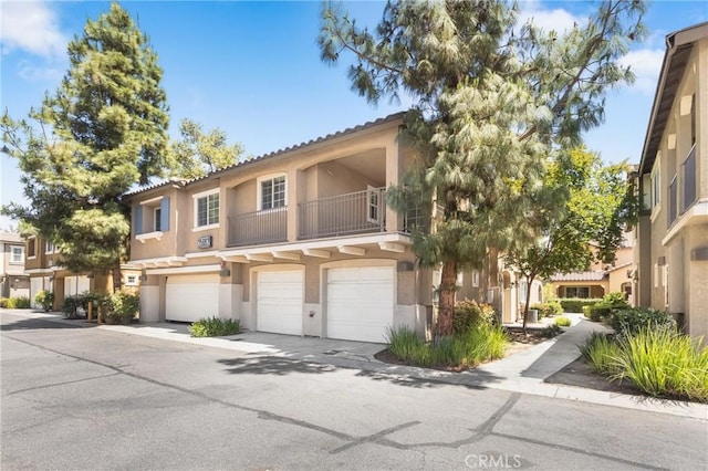 25892 Iris Ave Unit A, Moreno Valley, CA 92551 - multi unit property featuring stucco siding, a garage, and a balcony