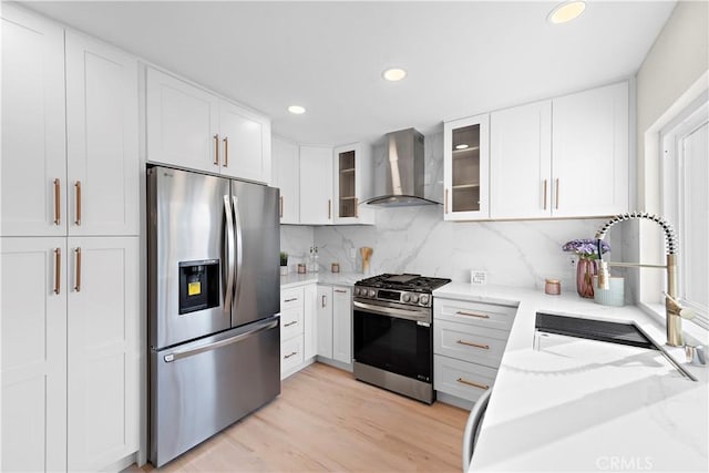 27751 Via Lorca, Mission Viejo, CA 92692 - kitchen with stainless steel appliances, wall chimney range hood, decorative backsplash, white cabinetry, and recessed lighting