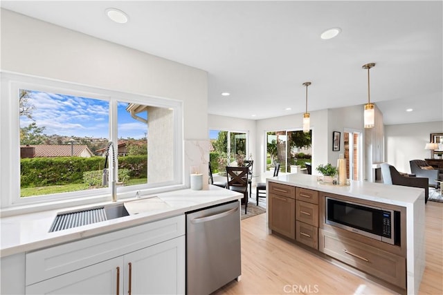 27751 Via Lorca, Mission Viejo, CA 92692 - kitchen featuring stainless steel dishwasher, built in microwave, a sink, light wood-style floors, and recessed lighting