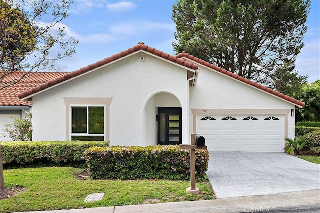 27751 Via Lorca, Mission Viejo, CA 92692 - mediterranean / spanish-style home featuring stucco siding, an attached garage, driveway, and a front lawn