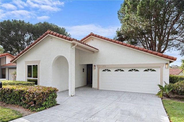 27751 Via Lorca, Mission Viejo, CA 92692 - mediterranean / spanish home featuring stucco siding, an attached garage, decorative driveway, and a tile roof