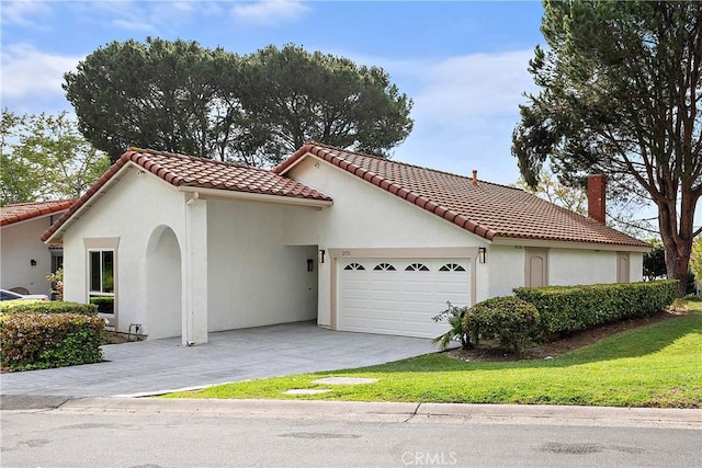 27751 Via Lorca, Mission Viejo, CA 92692 - mediterranean / spanish-style home with a garage, a tile roof, driveway, stucco siding, and a front yard