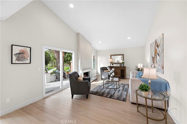 27751 Via Lorca, Mission Viejo, CA 92692 - living area with high vaulted ceiling, a fireplace, wood finished floors, baseboards, and recessed lighting