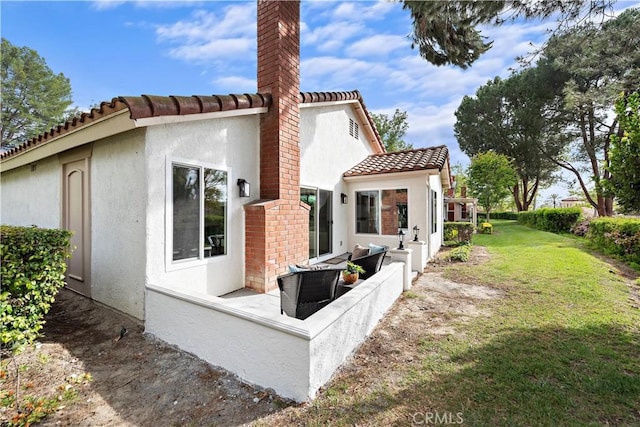 27751 Via Lorca, Mission Viejo, CA 92692 - back of house with stucco siding, a lawn, a tile roof, and a chimney