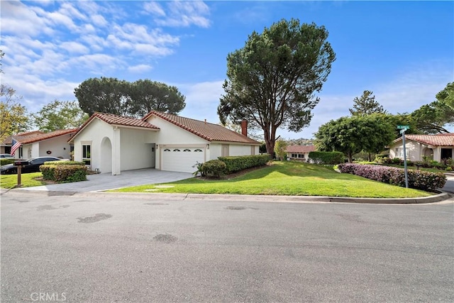 27751 Via Lorca, Mission Viejo, CA 92692 - mediterranean / spanish-style home with a garage, a tiled roof, driveway, a front yard, and stucco siding