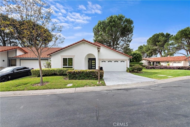 27751 Via Lorca, Mission Viejo, CA 92692 - mediterranean / spanish house featuring a garage, a front lawn, stucco siding, a tiled roof, and concrete driveway