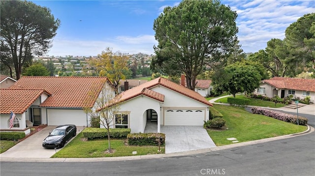 27751 Via Lorca, Mission Viejo, CA 92692 - view of front of home featuring a tile roof, an attached garage, concrete driveway, a front lawn, and stucco siding