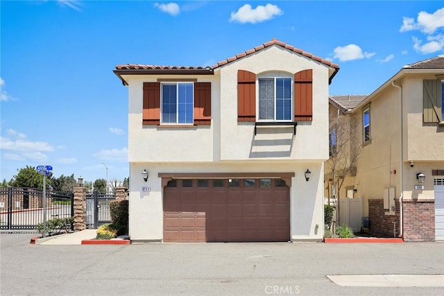 view of front of home featuring stucco siding, fence, and a tiled roof