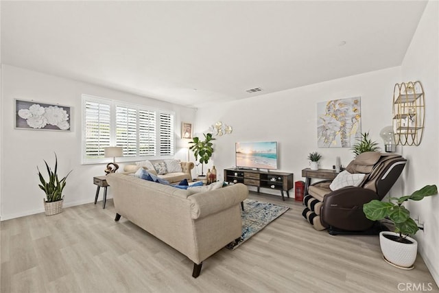 living area featuring light wood-type flooring and baseboards