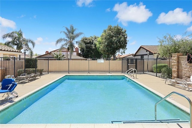 community pool featuring a patio and fence