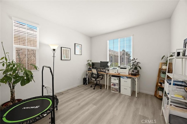 office area with light wood finished floors and baseboards