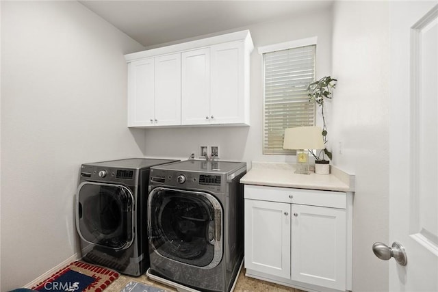 clothes washing area with cabinet space, independent washer and dryer, and baseboards