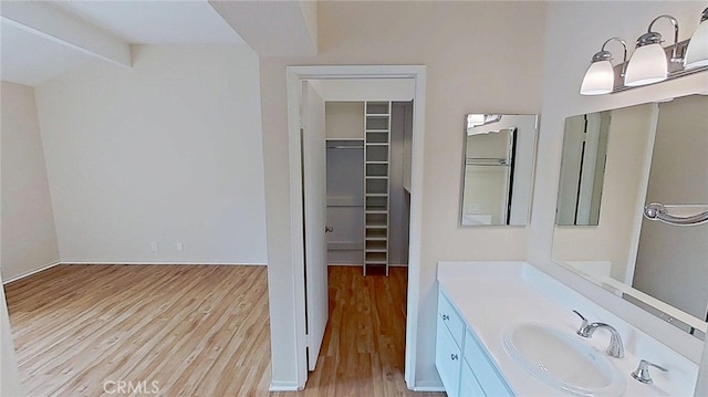 137 Corsica Dr, Newport Beach, CA 92660 - bathroom with wood finished floors, a walk in closet, and vanity