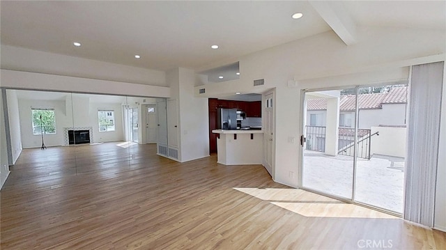 137 Corsica Dr, Newport Beach, CA 92660 - unfurnished living room with light wood-style flooring, a glass covered fireplace, and recessed lighting